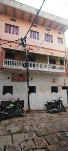 two motorcycles parked in front of a building at Sri Viswanatham Guest House in Varanasi
