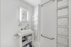 a white bathroom with a sink and a shower at Le Vendôme - Moderne & Elégant - Business in Paris
