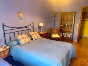 a bedroom with a blue bed with two pillows at LUXURY Positive House Gran Chaparral Toledo in Pepino
