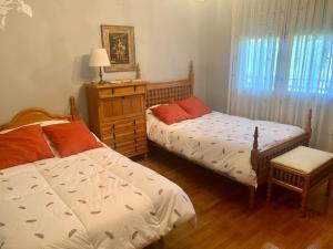 a bedroom with two beds and a table with a lamp at LUXURY Positive House Gran Chaparral Toledo in Pepino