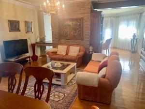 un soggiorno con un divano e un tavolo di LUXURY Positive House Gran Chaparral Toledo a Pepino