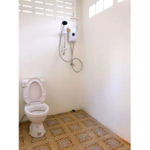 a bathroom with a toilet and a shower at Quality Time farm stay: Yard house in Ban Pa Lau