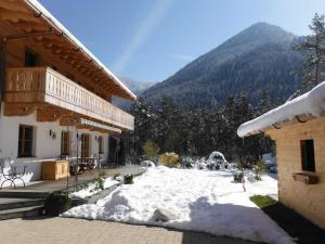 a snow covered yard in front of a building at Ferienwohnung Tegernsee,Fam Schneider, Kreuth-Grüneck in Kreuth +62 photos