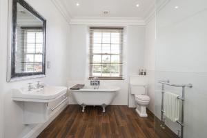 a bathroom with a tub and a sink and a toilet at Prospect House in York +17 photos