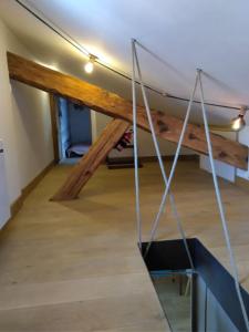 a room with wooden beams on the ceiling and a room with at Tiny duplex climatisé in Lyon