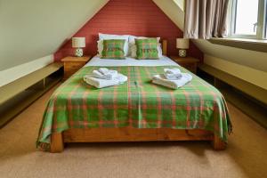 a bedroom with a bed with towels on it at Balnakeil Cattleman's Bothy in Durness +18 photos