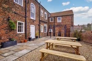 a wooden picnic table in front of a brick building at Prospect House in York