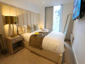 a bedroom with a large bed and a television at Pass the Keys Central 3x King Bed Suite 5 Min Deansgate Station in Manchester