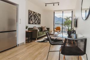 a living room with a table and chairs and a couch at 207 Le Jardin in George