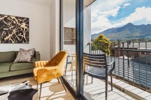 a living room with a couch and chairs on a balcony at 207 Le Jardin in George