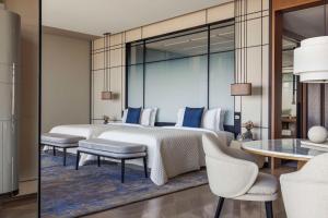 a bedroom with a bed and a table and chairs at One&Only One Za'abeel in Dubai