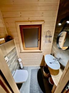 a small bathroom with a sink and a tv at Domek na Szlaku koło ZAKOPANEGO in Bańska Niżna +66 photos
