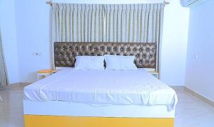 A bed or beds in a room at FabHotel Octagon Beach Resort