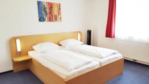 Postel nebo postele na pokoji v ubytování G&K Hotel