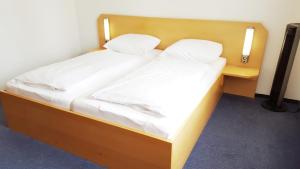 Postel nebo postele na pokoji v ubytování G&K Hotel