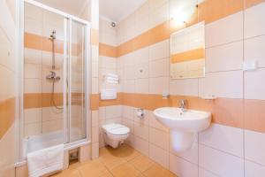 a bathroom with a toilet and a sink and a shower at Astra Dziwnówek Dom Gościnny in Dziwnówek +48 photos