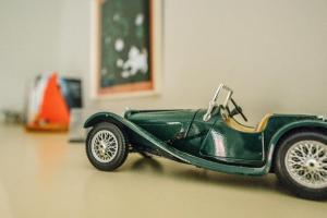 a green toy car is sitting on the floor at The Great House, Orford in Woodbridge