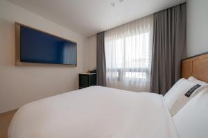 Postel nebo postele na pokoji v ubytování Hotel 701 Gyeongju