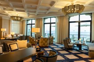 a hotel lobby with chairs and tables and windows at Four Seasons Hotel Tunis in Gammarth