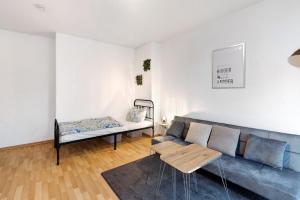 uma sala de estar com um sofá e uma mesa em Wohnen am Wissenschaftshafen em Magdeburg