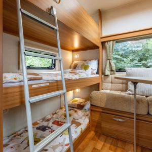 a bedroom with bunk beds in a tiny house at Luxury Luna in Whitchurch