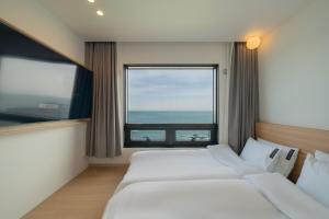 Postel nebo postele na pokoji v ubytování Hotel 701 Gyeongju