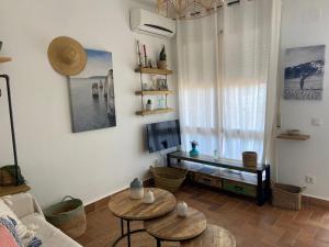 a living room with two tables and a couch at Estudio vistas al mar y a 5 minutos playa Estartit in L'Estartit
