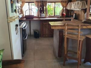 a kitchen with a wooden counter and a refrigerator at Quindio in Barra del Chuy