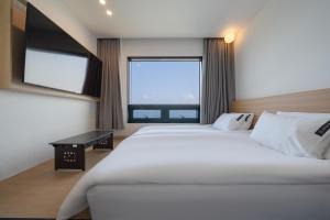 Postel nebo postele na pokoji v ubytování Hotel 701 Gyeongju