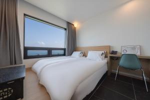 Postel nebo postele na pokoji v ubytování Hotel 701 Gyeongju