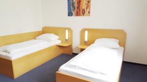 Postel nebo postele na pokoji v ubytování G&K Hotel
