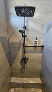 a shower with a black rack in a bathroom at Residence Oceana 4 in Mont Choisy +8 photos