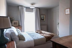 a bedroom with a bed and a window at Luxury family and dog friendly cottage in North Norfolk, Aylsham in Aylsham