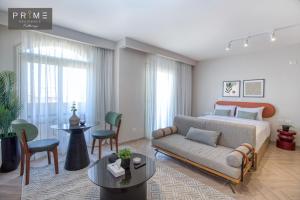 a bedroom with a bed and a couch and a table at Prime Residence Kattameya in Cairo