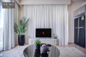 a living room with a laptop computer on a table at Prime Residence Kattameya in Cairo