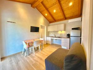 a living room with a table and a kitchen at Villaggio Camping Valdeiva in Deiva Marina