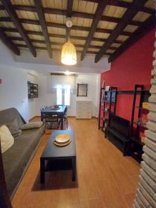 a living room with a couch and a table at Casa El Molino in Conil de la Frontera