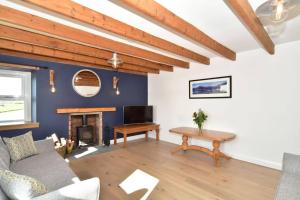 a living room with a couch and a fireplace at Impeccable 2-Bed Cottage in Johnshaven in Montrose