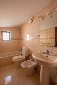 a bathroom with a toilet and a sink at A House With a View in Aljezur