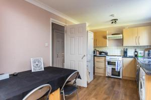 a kitchen with a table with a black table cloth on it at Spacious 2BD House wPrivate Garden - Kennington! in London
