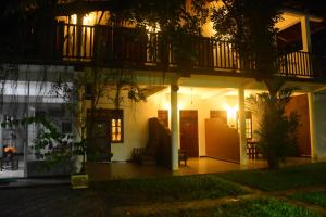 a house at night with a balcony at Royal Inside Hotel in Udawalawe