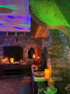 a restaurant with a table with food and a stone fireplace at Le Domaine des Anges 