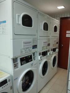 four washing machines stacked up in a laundrette at Queen's Flats in Brasilia