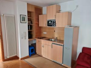 a small kitchen with a sink and a refrigerator at Ambiente Ferienwohnungen in Sankt Martin