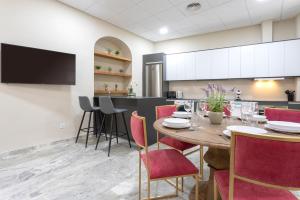 a dining room and kitchen with a table and chairs at Genteel Home Plaza de las Tendillas II in Córdoba