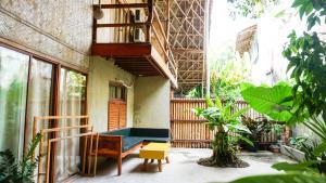 a balcony of a house with a bench and a table at Happiness Vacation Villa El Nido in El Nido