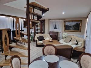 a living room with a loft bed and a table at Apartmánový dom v Panoráma Parku in Nezbudská Lúčka