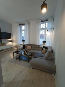 a living room with a couch and a table at Apartament blisko dwóch jezior na Warmii i Mazurach in Biskupiec
