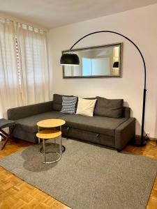 a living room with a couch and a table at Central 2 bedroom flat in heart of Eaux-vives in Geneva