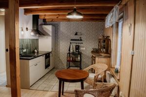 a kitchen with a table and chairs in a room at Gaj-Raj in Łąkorz